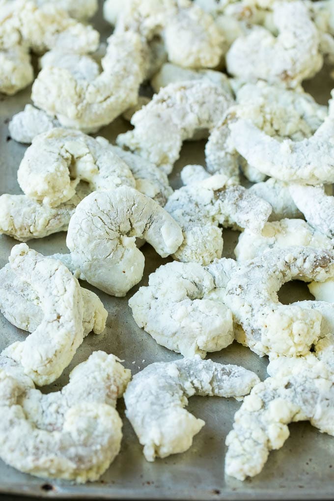Bang Bang Shrimp Recipe | Fried Shrimp #shrimp #appetizer #dinner #sraye #copycatrecipe Shrimp coated in cornstarch on a sheet pan.