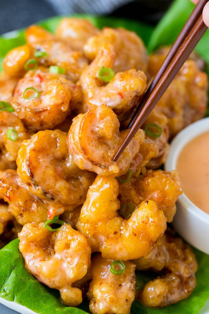 Bang Bang Shrimp Recipe | Fried Shrimp #shrimp #appetizer #dinner #sraye #copycatrecipe A pair of chopsticks picking up bang bang shrimp.