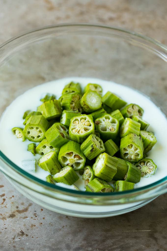 Fried Okra Recipe #okra #appetizer #sidedish #sraye Sliced okra in a bowl of buttermilk.