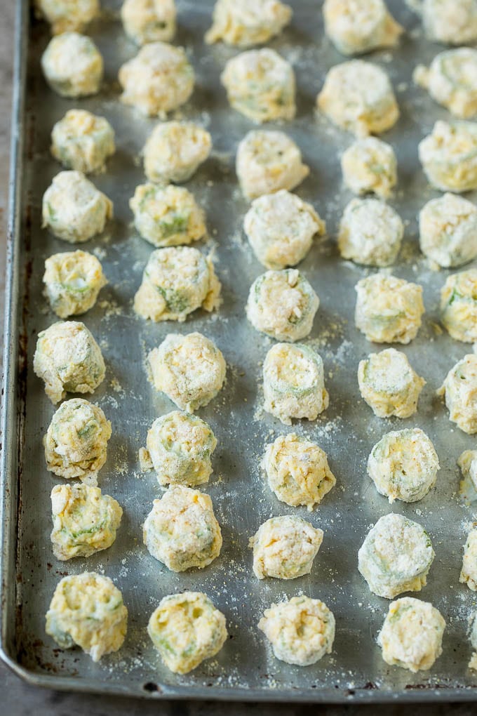 Fried Okra Recipe #okra #appetizer #sidedish #sraye Breaded okra slices on a sheet pan.