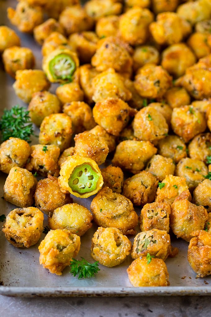 Fried Okra Recipe #okra #appetizer #sidedish #sraye Fried okra on a sheet pan, garnished with chopped parsley.