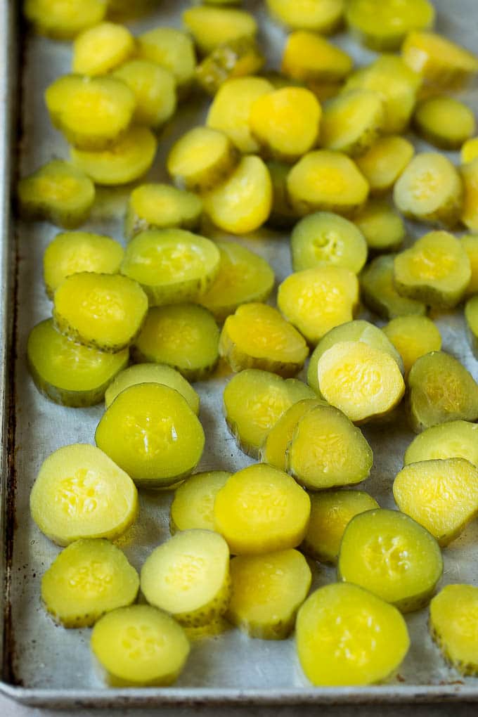 Fried Pickles Recipe #pickles #appetizer #snack #sraye Sliced dills on a sheet pan.