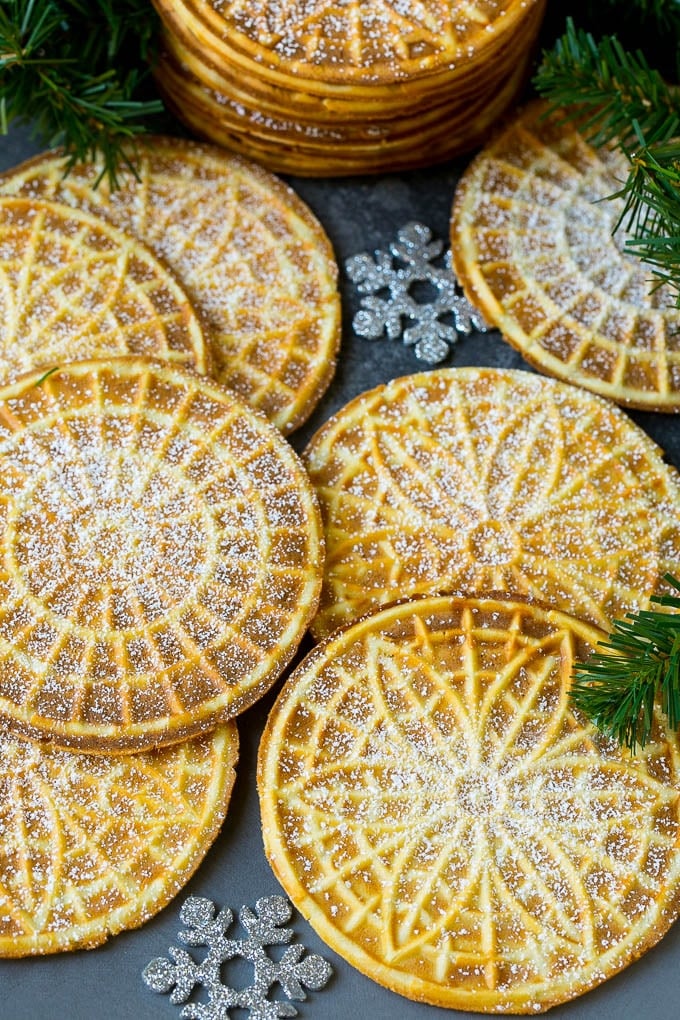 Pizzelle Cookies Recipe #cookies #baking #dessert #christmas #sraye Pizzelle cookies cooked to golden brown and coated in powdered sugar.