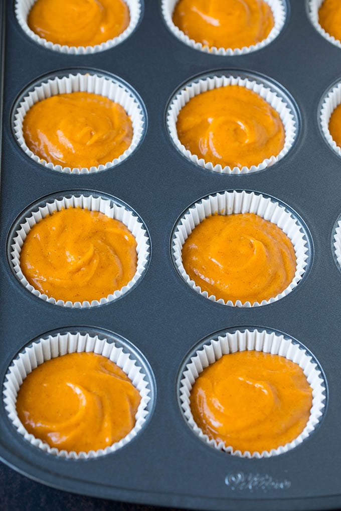 Pumpkin Cupcakes Recipe | Pumpkin Cake #cake #cupcakes #pumpkin #frosting #baking #fall #thanksgiving #sraye Batter inside paper cups in a muffin tin.