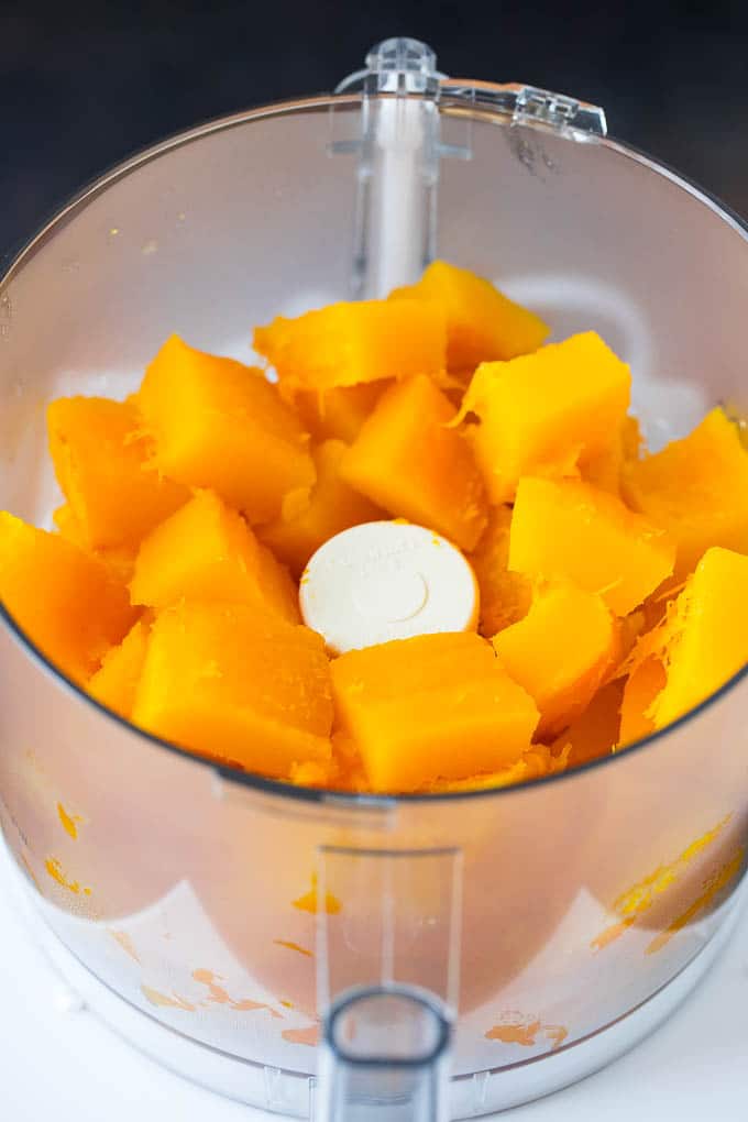 Pumpkin Puree Recipe #pumpkin #baking #fall #thanksgiving #sraye Cubes of pumpkin in a food processor.