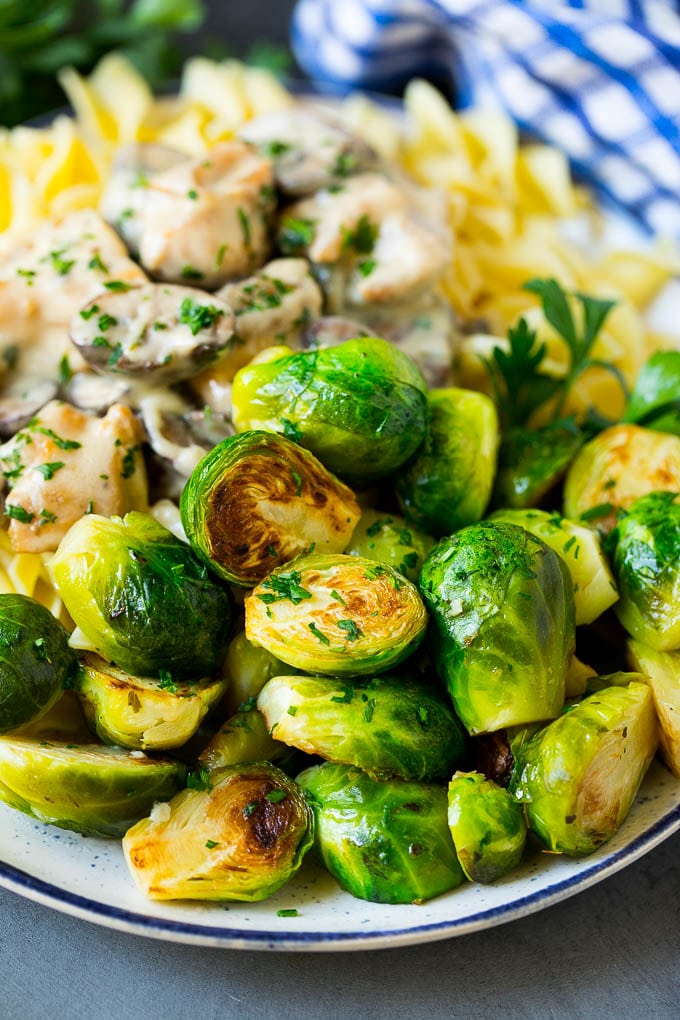 Sauteed Brussels Sprouts Recipe | Brussels Sprouts Side Dish #brusselssprouts #sprouts #veggies #sidedish #garlic #vegetarian #dinner #sraye Sauteed brussels sprouts served alongside chicken and noodles.