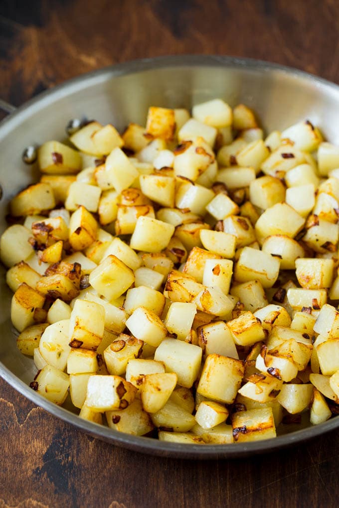 Corned Beef Hash Recipe #hash #cornedbeef #stpatricksday #breakfast #brunch #potatoes #sraye Sauteed potatoes in a skillet.