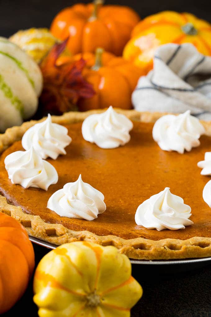 Homemade Pumpkin Pie Recipe | Pumpkin Pie #pie #pumpkin #baking #thanksgiving #fall #dessert #sraye Homemade pumpin pie topped with rosettes of whipped cream.