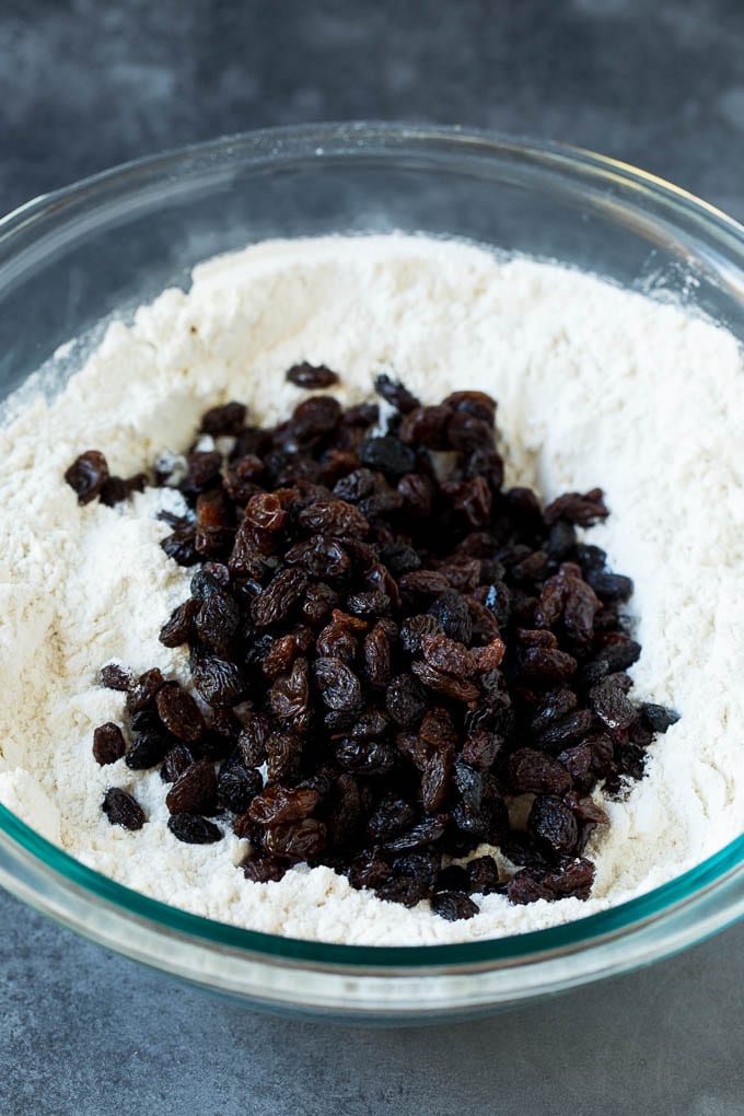 Irish Soda Bread Recipe #bread #baking #stpatricksday #sidedish #sraye Flour, sugar, butter, baking powder and raisins in a mixing bowl.