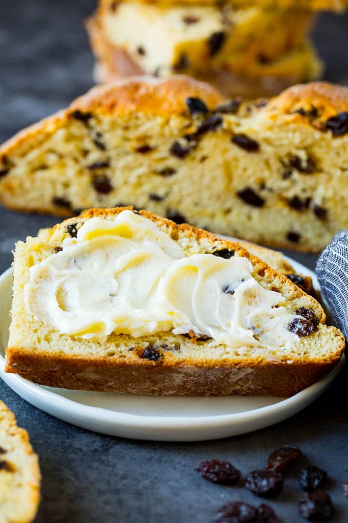 Irish Soda Bread Recipe #bread #baking #stpatricksday #sidedish #sraye A slice of Irish soda bread with butter spread on it.