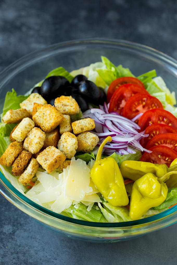 Olive Garden Salad Recipe | Italian Salad #salad #lettuce #olives #sidedish #dinner #sraye Lettuce, vegetables, olives and croutons in a bowl.