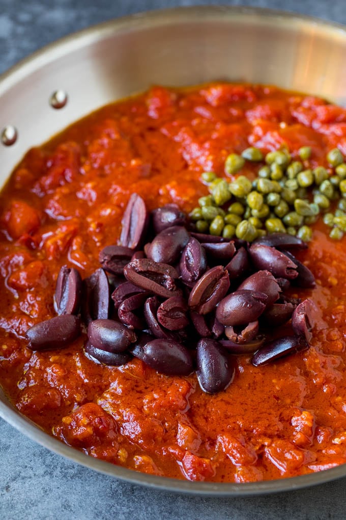 Pasta Puttanesca Recipe #pasta #tomatoes #olives #italianfood #dinner #sraye Tomato sauce with olives and capers on top.
