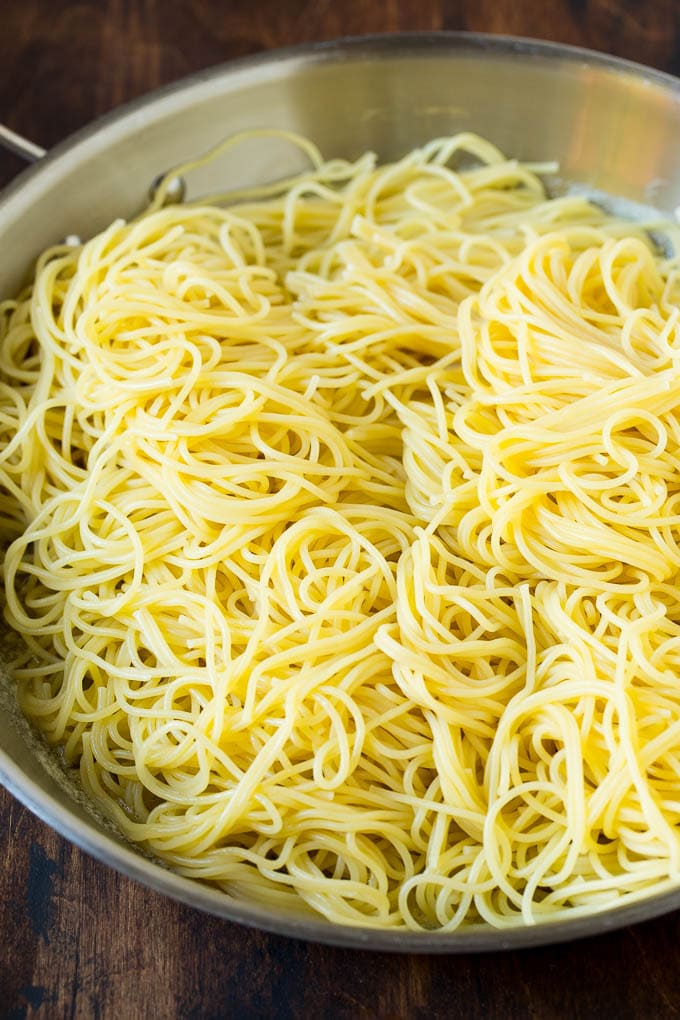 Garlic and Herb Angel Hair Pasta #pasta #garlic #sidedish #dinner #sraye Pasta in a pan with garlic and butter.