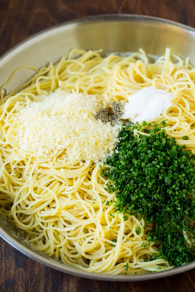 Garlic and Herb Angel Hair Pasta #pasta #garlic #sidedish #dinner #sraye Pasta topped with herbs, cheese, salt and pepper.