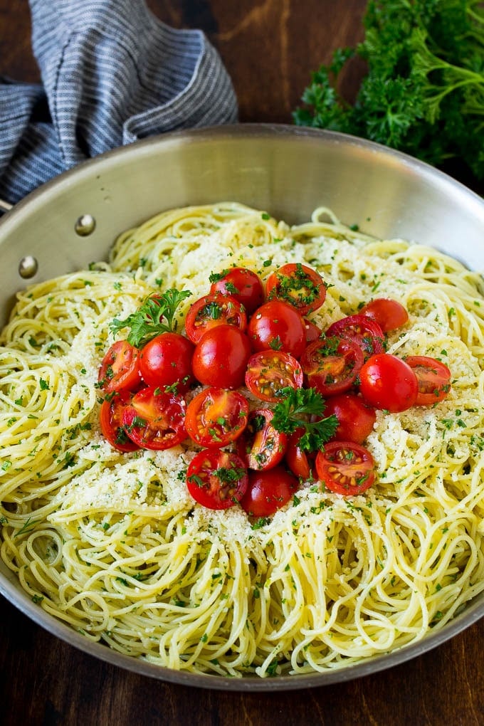 Garlic and Herb Angel Hair Pasta #pasta #garlic #sidedish #dinner #sraye Garlic and herb angel hair pasta topped with fresh tomatoes.