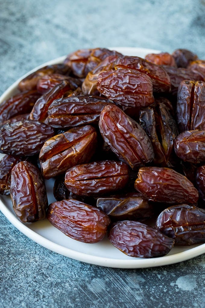Bacon Wrapped Dates #appetizer #bacon #dates #cheese #sraye Dates split open on a plate.