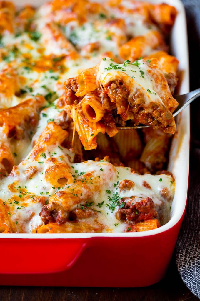 Baked Rigatoni Pasta #pasta #dinner #italianfood #groundbeef #sraye #casserole A spoon serving up a portion of baked rigatoni pasta.