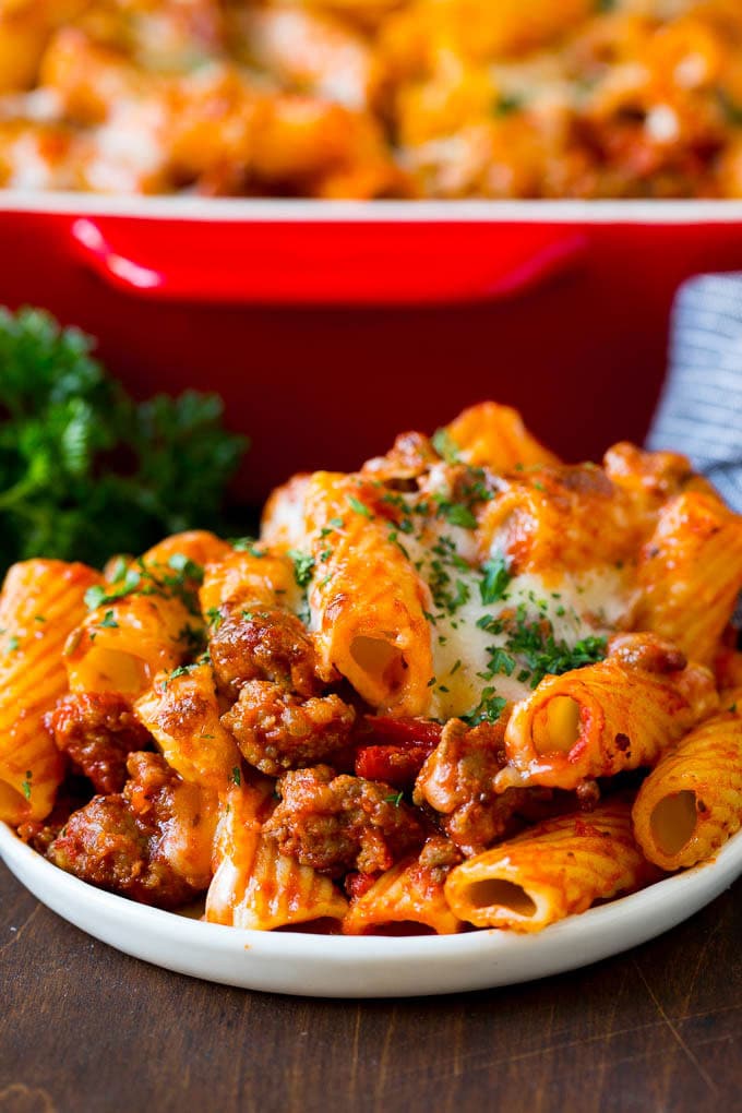 Baked Rigatoni Pasta #pasta #dinner #italianfood #groundbeef #sraye #casserole A plate of baked rigatoni topped with melted cheese.
