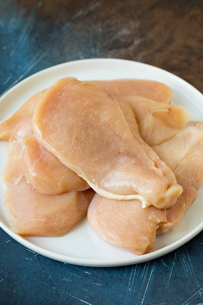 Chicken Francese Recipe #chicken #lemon #dinner #sraye Thin cut chicken breasts on a plate.