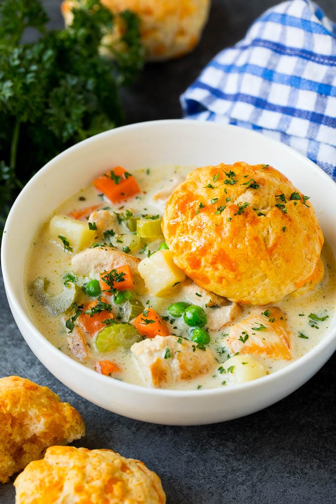 Chicken Pot Pie Soup Recipe | Chicken Soup #soup #chicken #dinner #comfortfood #sraye A bowl of chicken pot pie soup with a biscuit on top.