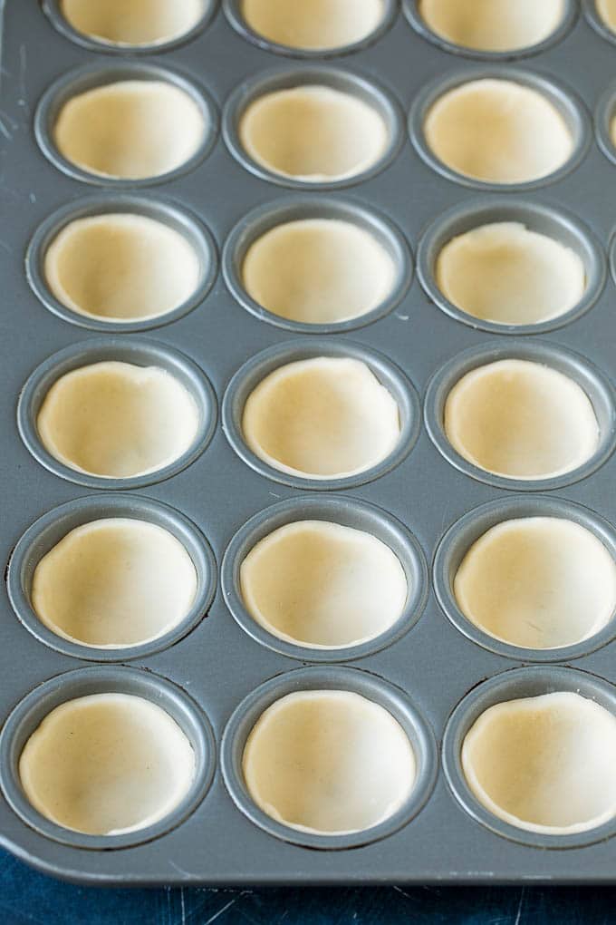 Mini Quiche Recipe #eggs #breakfast #brunch #appetizer #sraye Pie crust rounds pressed into muffin tins.