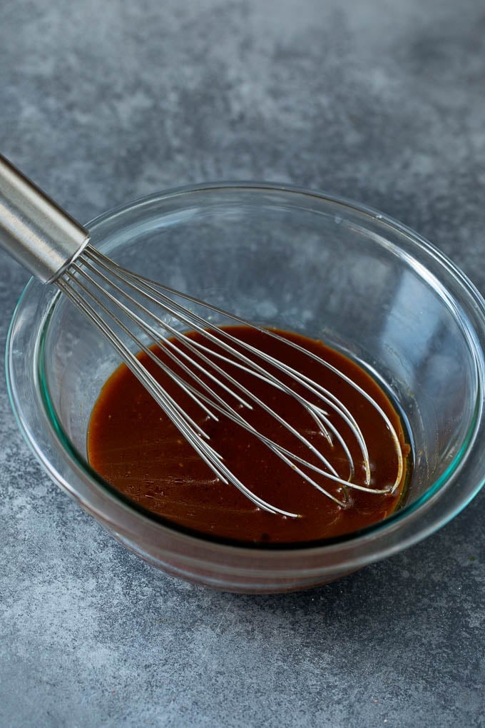 Asian Slaw Recipe #salad #slaw #sidedish #sraye A bowl of homemade sesame ginger dressing.