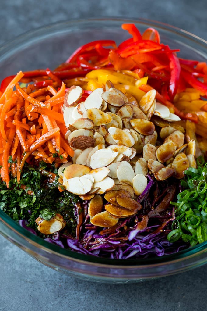 Asian Slaw Recipe #salad #slaw #sidedish #sraye Homemade dressing poured over Asian coleslaw.