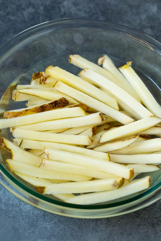 Homemade French Fries Recipe #potatoes #fries #dinner #sraye Sliced potato sticks in a bowl of water.
