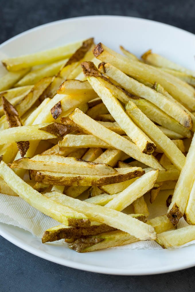 Homemade French Fries Recipe #potatoes #fries #dinner #sraye Par-fried potatoes on a plate.