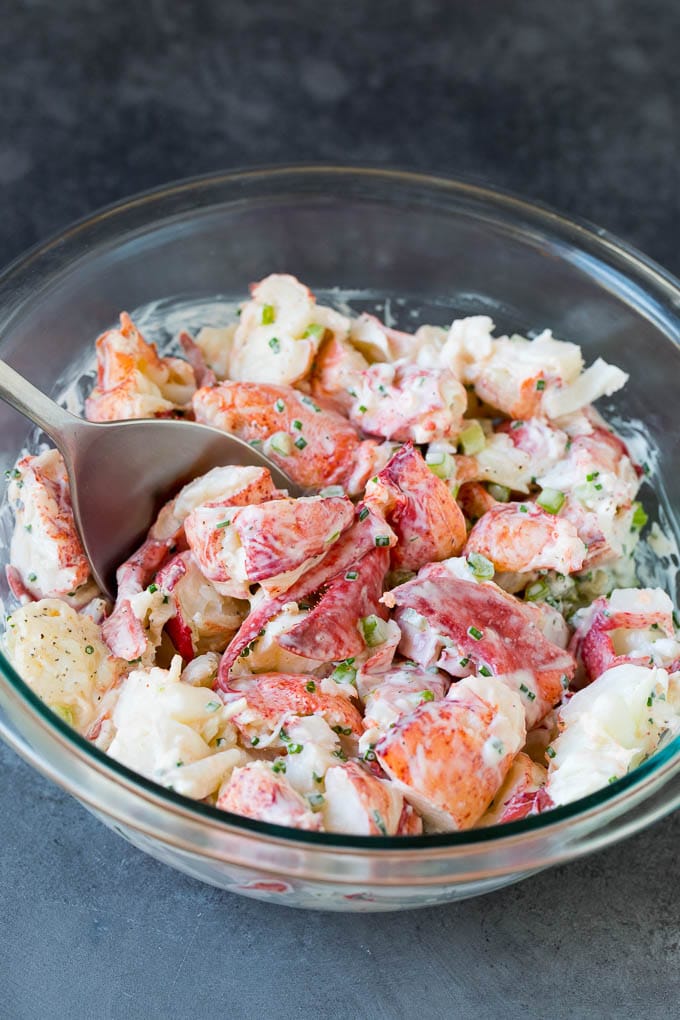 Lobster rolls stuffed with creamy lobster salad in a toasted bun. #lobster #sraye Lobster salad in a bowl in a creamy dressing.