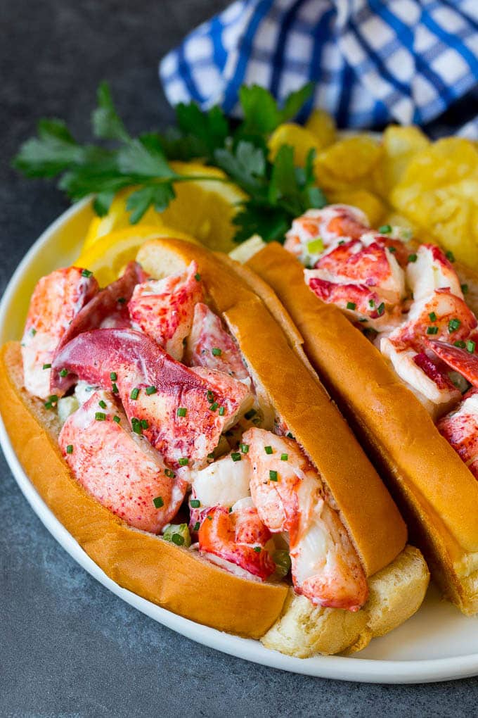 Lobster rolls stuffed with creamy lobster salad in a toasted bun. #lobster #sraye Lobster roll with chunks of fresh lobster meat in a buttered and toasted bun.