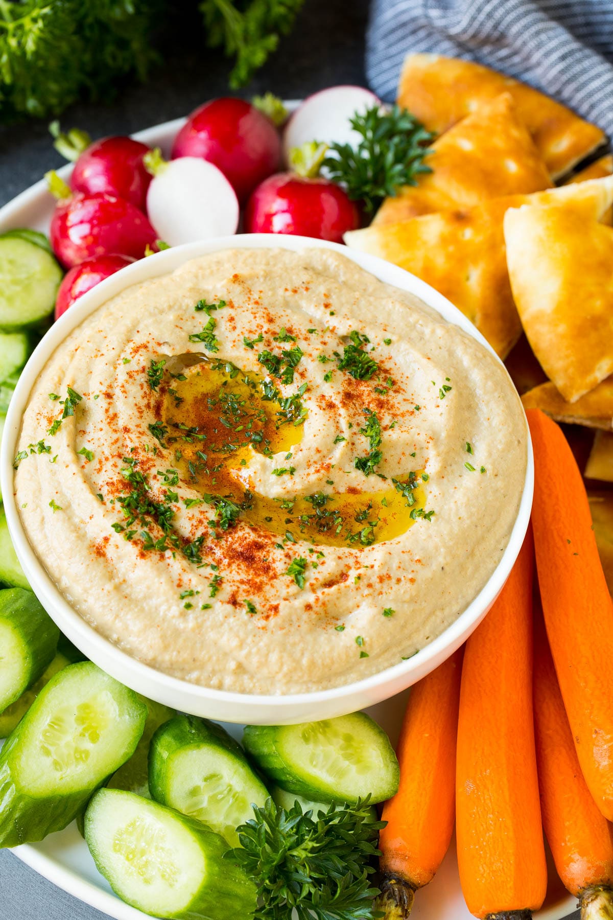Baba Ganoush Recipe | Eggplant Dip #eggplant #appetizer #dip #healthy #glutenfree #lowcarb #sraye Baba ganoush in a bowl surrounded by bread and vegetables.