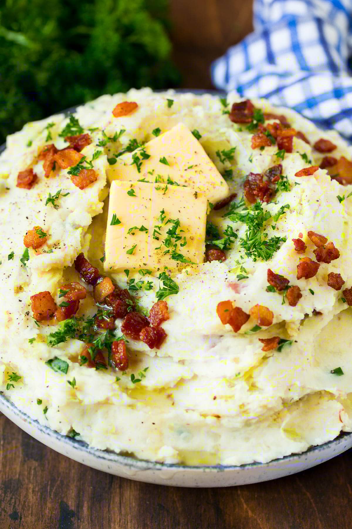 Colcannon Recipe | Mashed Potatoes #potatoes #cabbage #bacon #sidedish #stpatricksday #dinner #sraye A serving bowl of colcannon topped with butter and herbs.