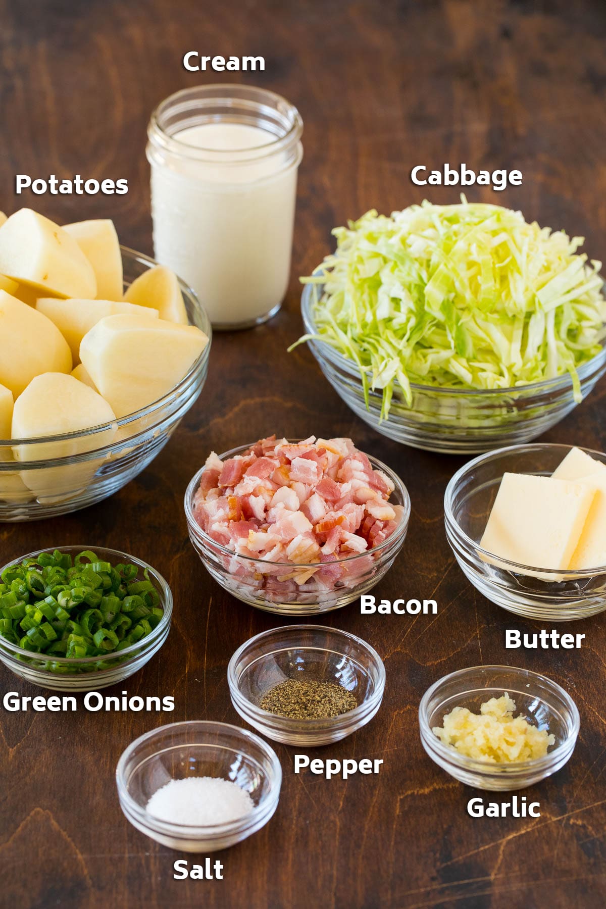 Colcannon Recipe | Mashed Potatoes #potatoes #cabbage #bacon #sidedish #stpatricksday #dinner #sraye Bowls of bacon, cabbage, potatoes, and seasonings.