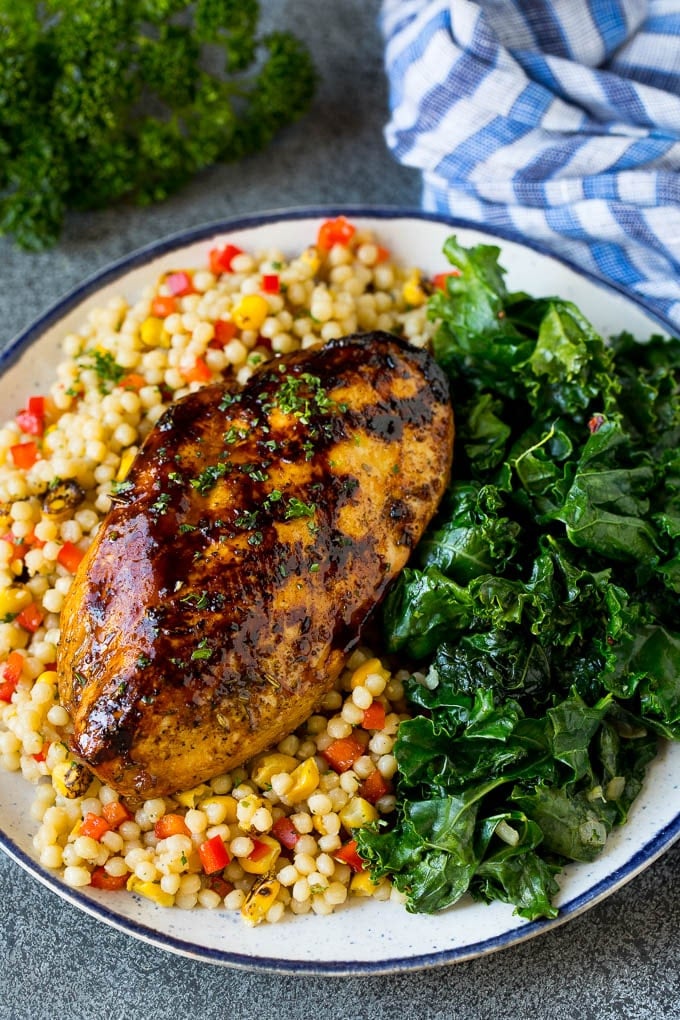 Sauteed kale flavored with olive oil and garlic, a quick and easy side dish! #kale #sraye Grilled chicken served with a side of sauteed kale.