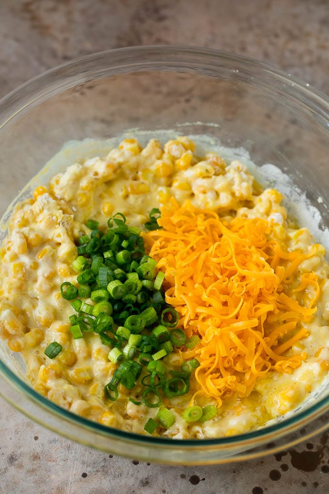 These crispy corn fritters are easy to make and are the perfect appetizer or lighter main course. #corn #sraye Corn batter topped with green onions and shredded cheese.