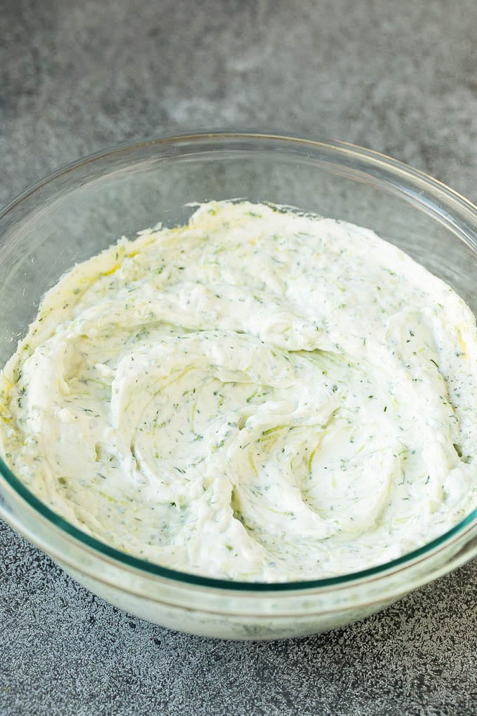 The best homemade tzatziki sauce with cucumber and herbs mixed into Greek yogurt. #appetizer #sraye Tzatziki sauce in a glass bowl.